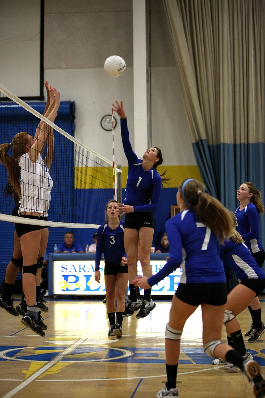Nicole Wittmer, No. 1, hits the ball over the net.