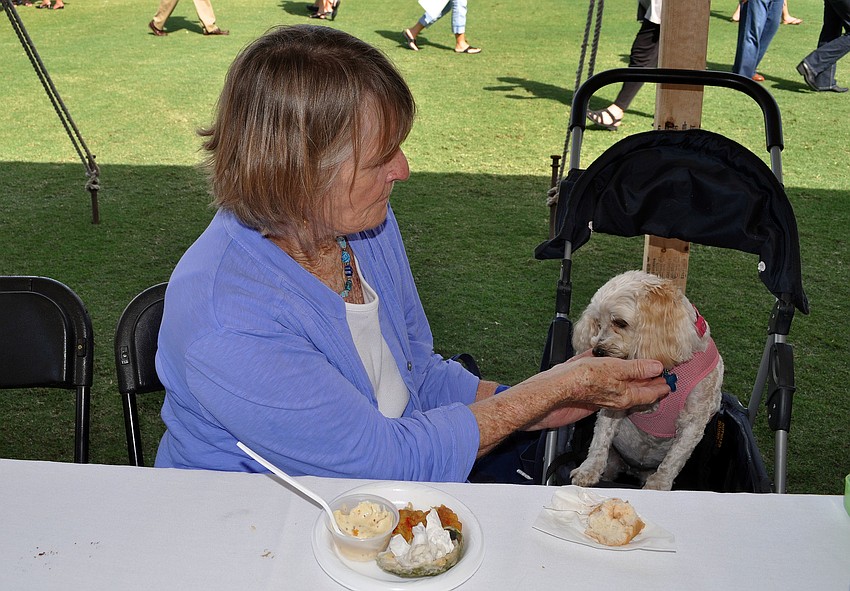 Bobbie Banan gives her dog Pumpkin, 5, a piece of bread.