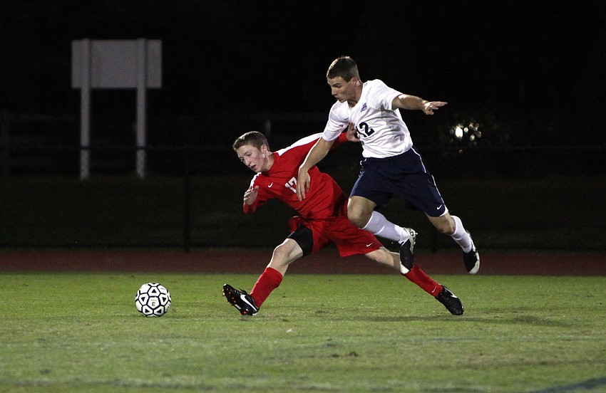 Cardinal Mooney's Blake Young, No. 17, and ODA's Hunter Clarke, No. 12, go after the ball.