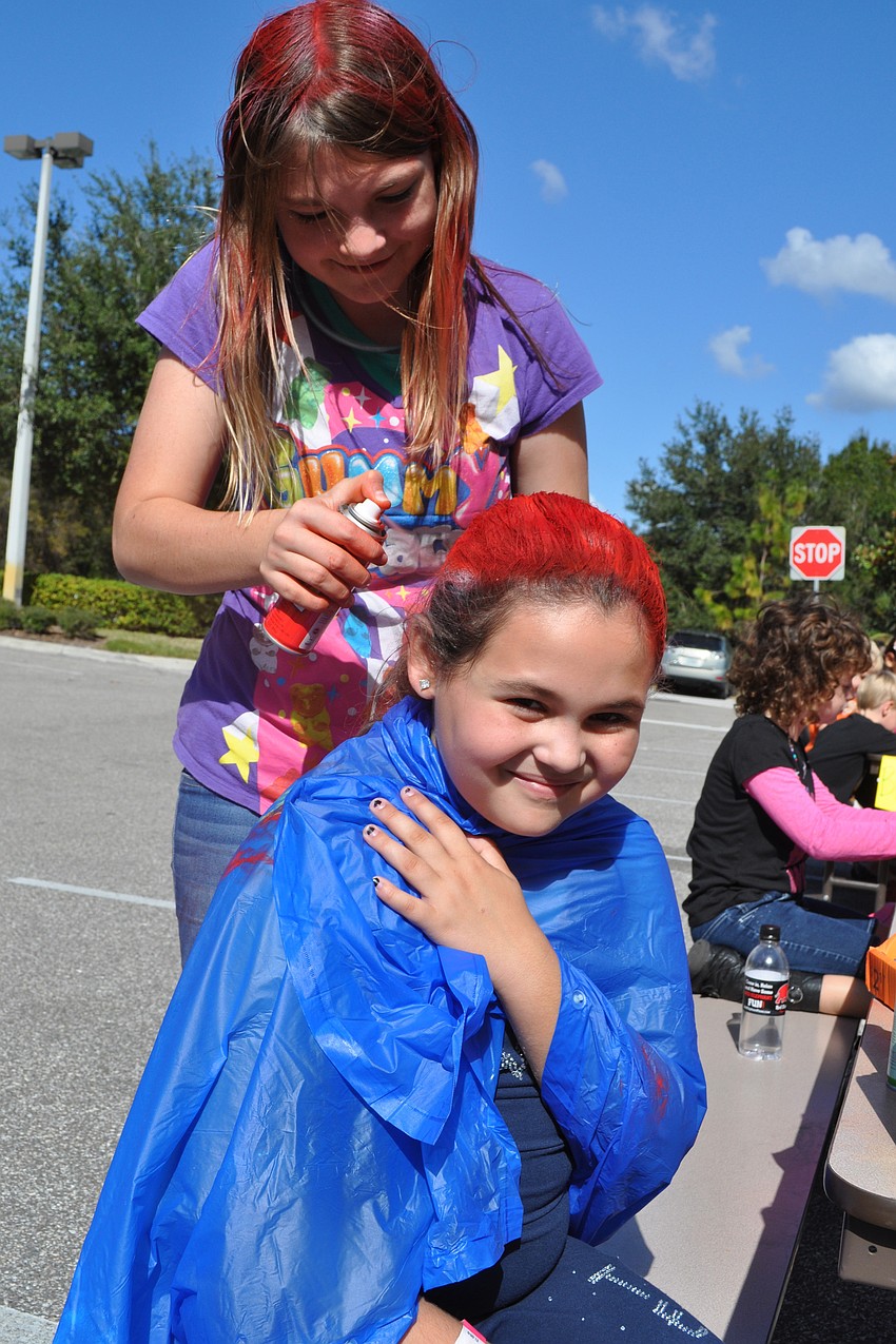 McKenzie Moritz spray painted the hair of Katana Carotti-Goldberg bright red.