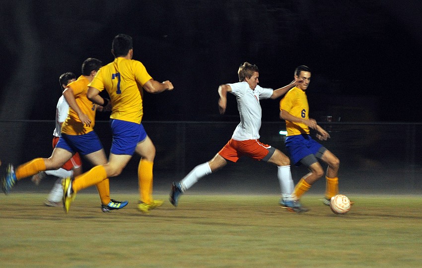 Sarasota High Schoolâ€™s Scott Piece, No. 9, breaks out into a sprint down the field to try and keep the ball from being taken back by Sarasota Military Academyâ€™s Mitchell Jones, No. 6.