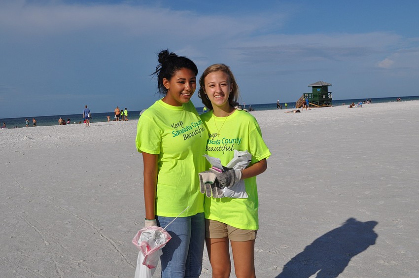 Jazlyn Qualls, 15, and Adrianne Stolpe, 15, are one of at least 30 Riverview High School students who joined beach cleanup efforts.