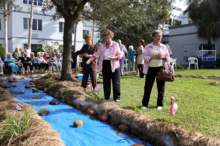 Residents of the Kobernick House were the first to throw their fish crackers into the â€œRiver Jordanâ€ Tuesday, Sept. 18 during the Tashlich ceremony by the Anchin Pavilion.