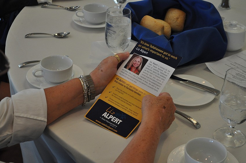 Sarah Tate looks over Liz Alpertâ€™s flyer.