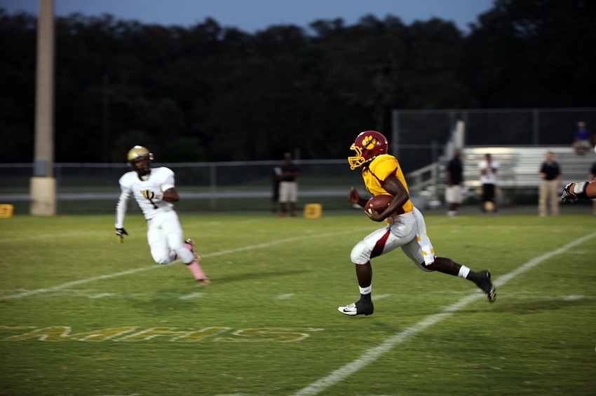 Chris White, No. 1, tries to stay ahead of Demardre Patterson, No. 7, during Friday nightâ€™s game at Cardinal Mooney.