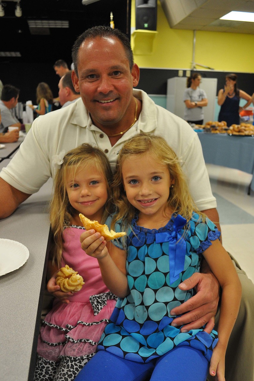 Morgan and Natalie Fellows feasted on doughnuts with their dad, George.