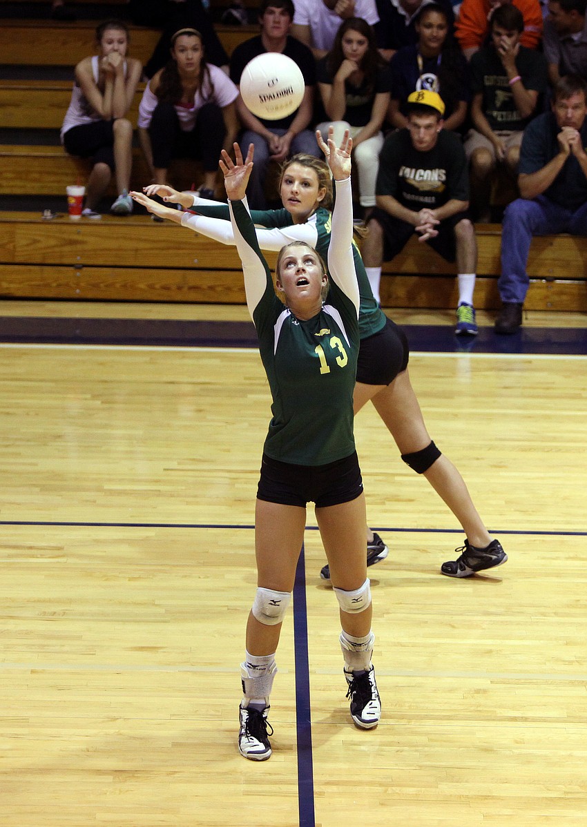 Natalie Marciniak, No. 13, sets the ball.
