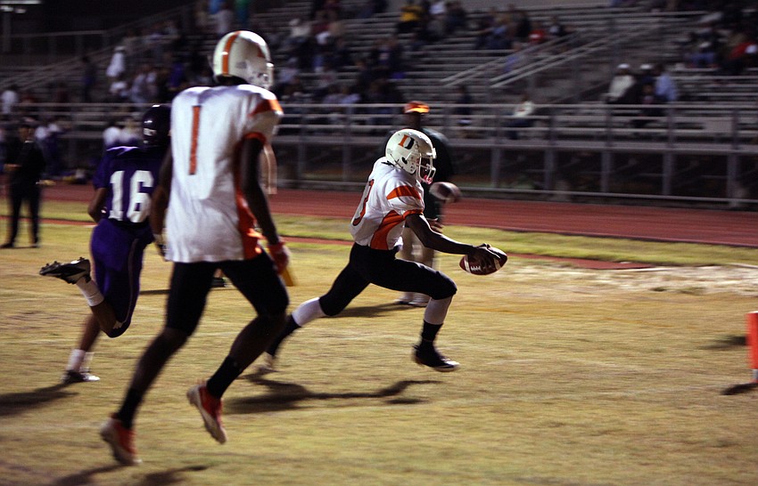 Daniel Cobb, No. 3, makes the first touchdown of the evening for the Dunbar Tigers Friday, Nov. 2, at Booker High School.