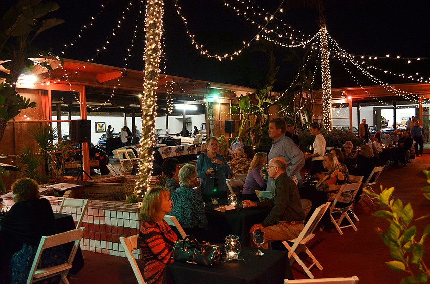 People enjoyed cocktails and passed hors d'oeuvres under lights and surrounded by vintage cars.