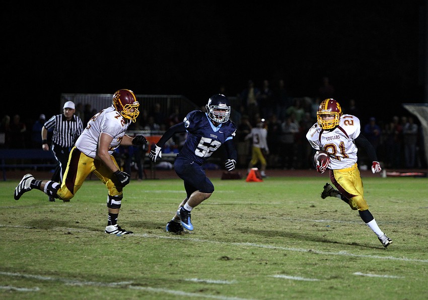 Wyatt Knopfke, No. 72, stays close and tries to ward off Max Provost, No. 52, as Alex Sobczak, No. 21, runs up field with the ball.