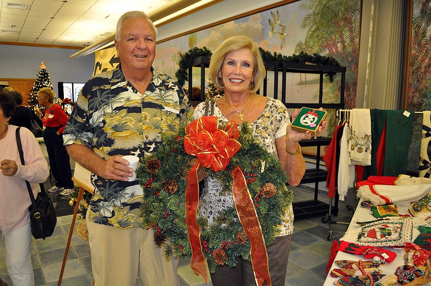 Ed Ryan with a cup of coffee and Eleanor Pugliesi with a wreath and an ornament she was planning to buy.