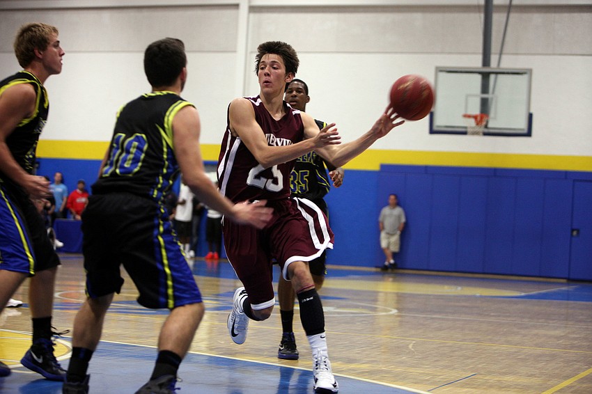 Nick Havener, No. 25, dribbles the ball towards the hoop.