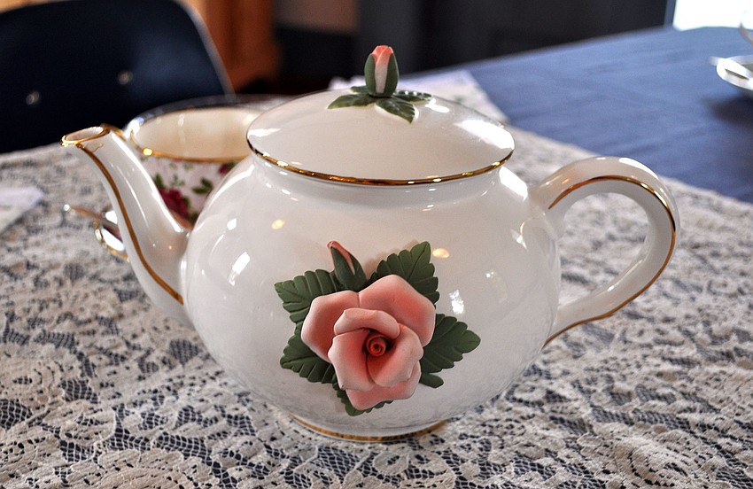A rose-themed teapot.