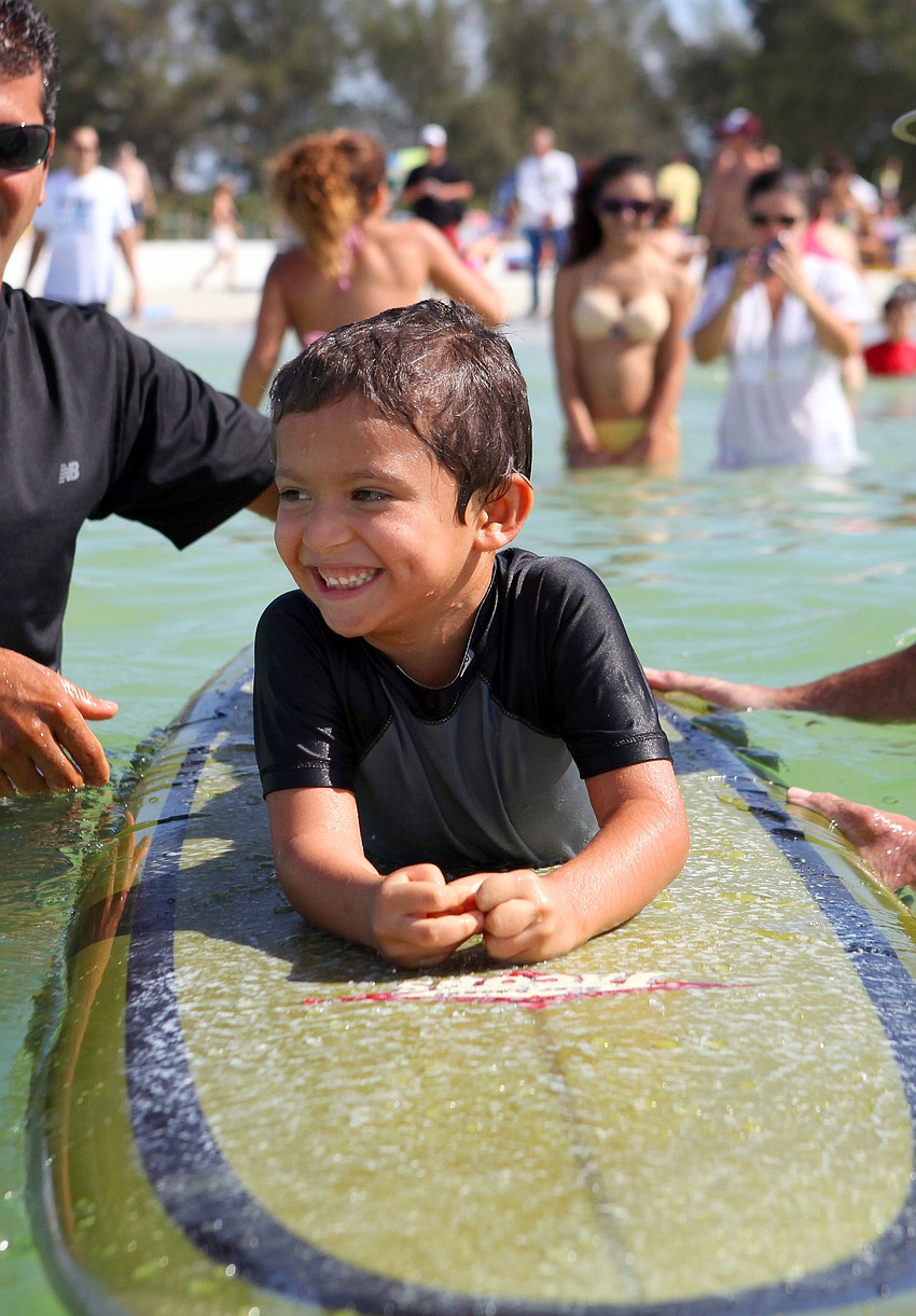 Jeremy Ortiz, 6, smiles big Saturday, Sept. 15 while taking part in Hang 10 for Autism.