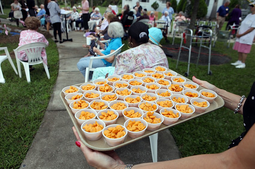 Fish crackers were given out in little plastic cups for the residents to throw into the â€œRiver Jordanâ€.