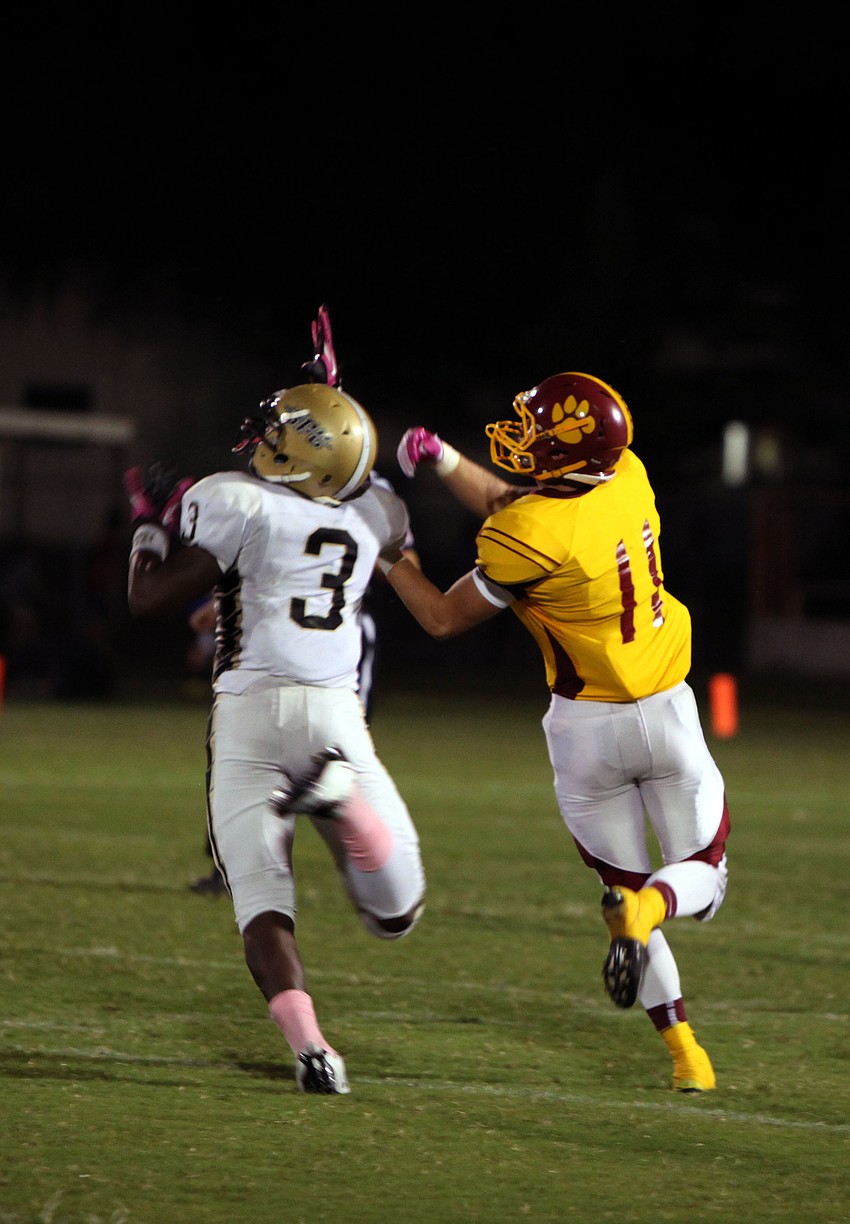 Tony Jones, No. 3, and Casey Gunderson, No. 11 both try to set themselves up to catch the ball.