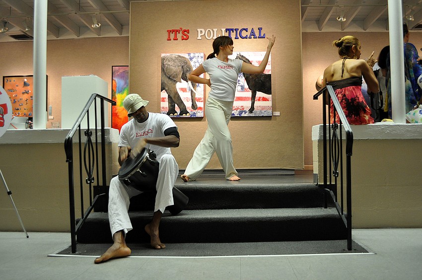 Jahred Thompson plays percussion while Mary Richardson dances.