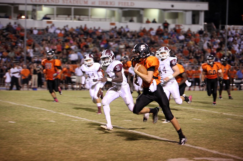 Hunter DeWitt, No. 10, makes his way down the field as Riverview players attempt to catch him.