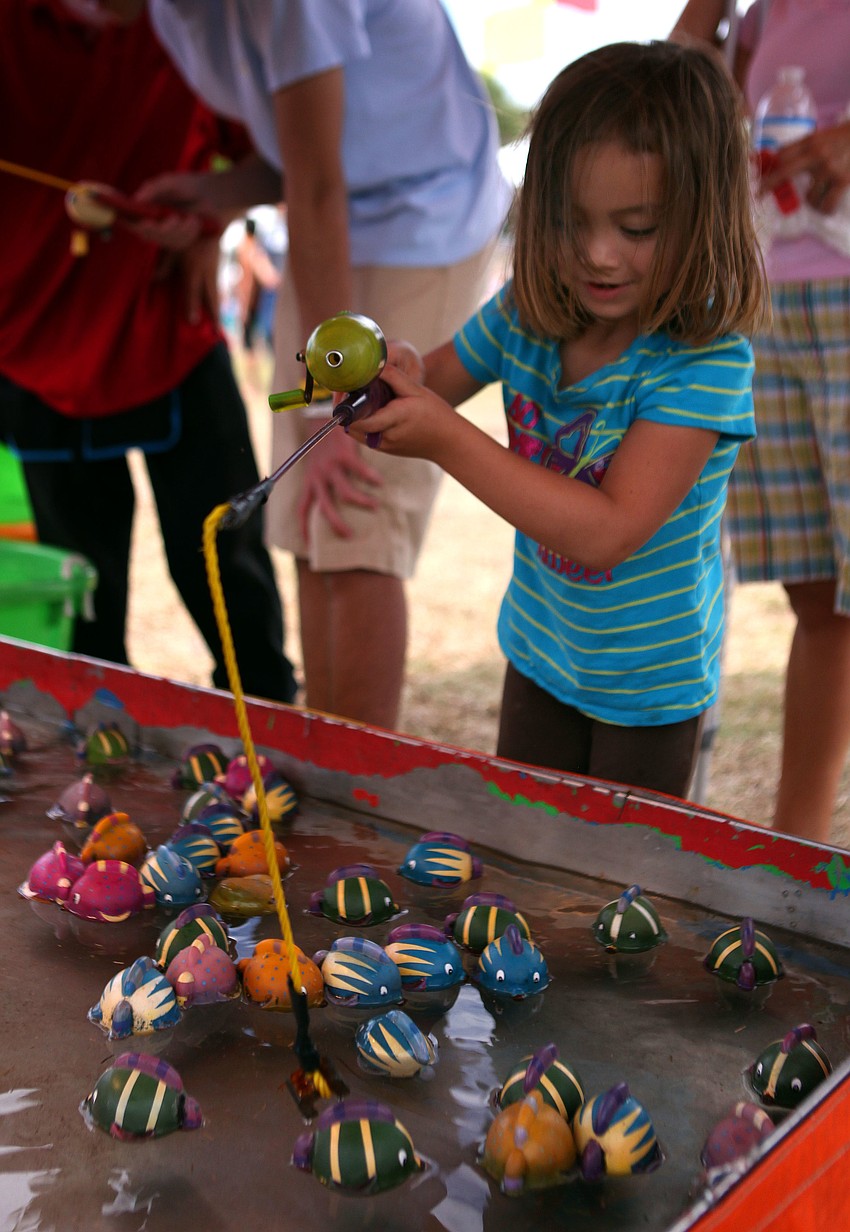 Tali Spencer, 5, has fun fishing for plastic fish.