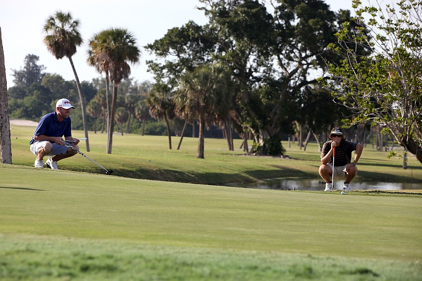 Ryan Gildersleeve and Jhared Hack both crouch down on the 18th hole to figure out how to take their final shots.