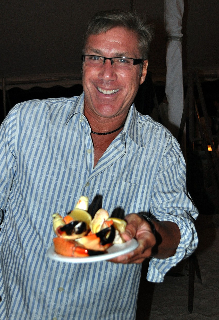 Bryan Ripellino fills his plate up with stone crab.