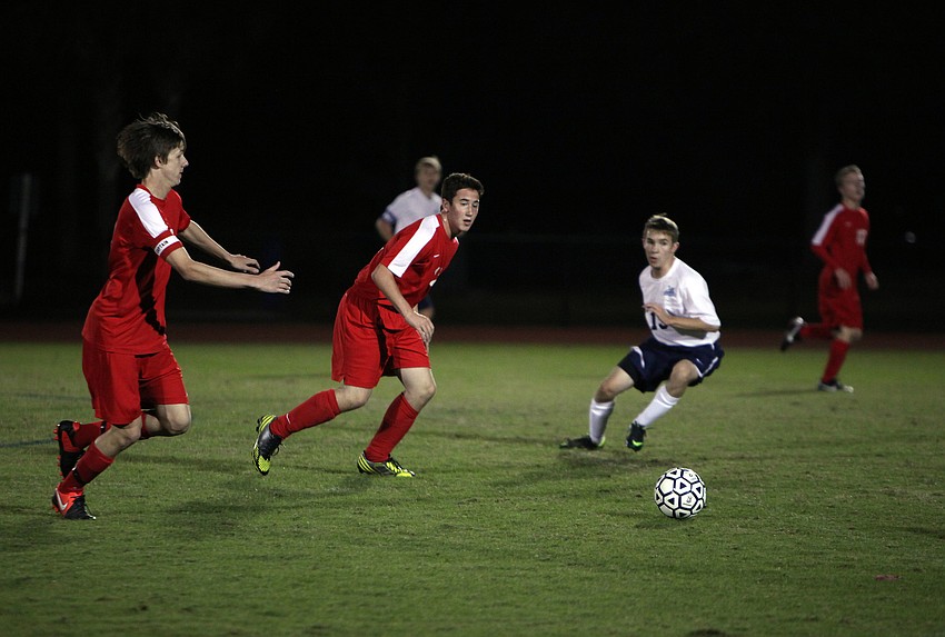 Cardinal Mooneyâ€™s Greg Illig, No. 10, and Jake LaDemina, No. 12, run towards the ball.