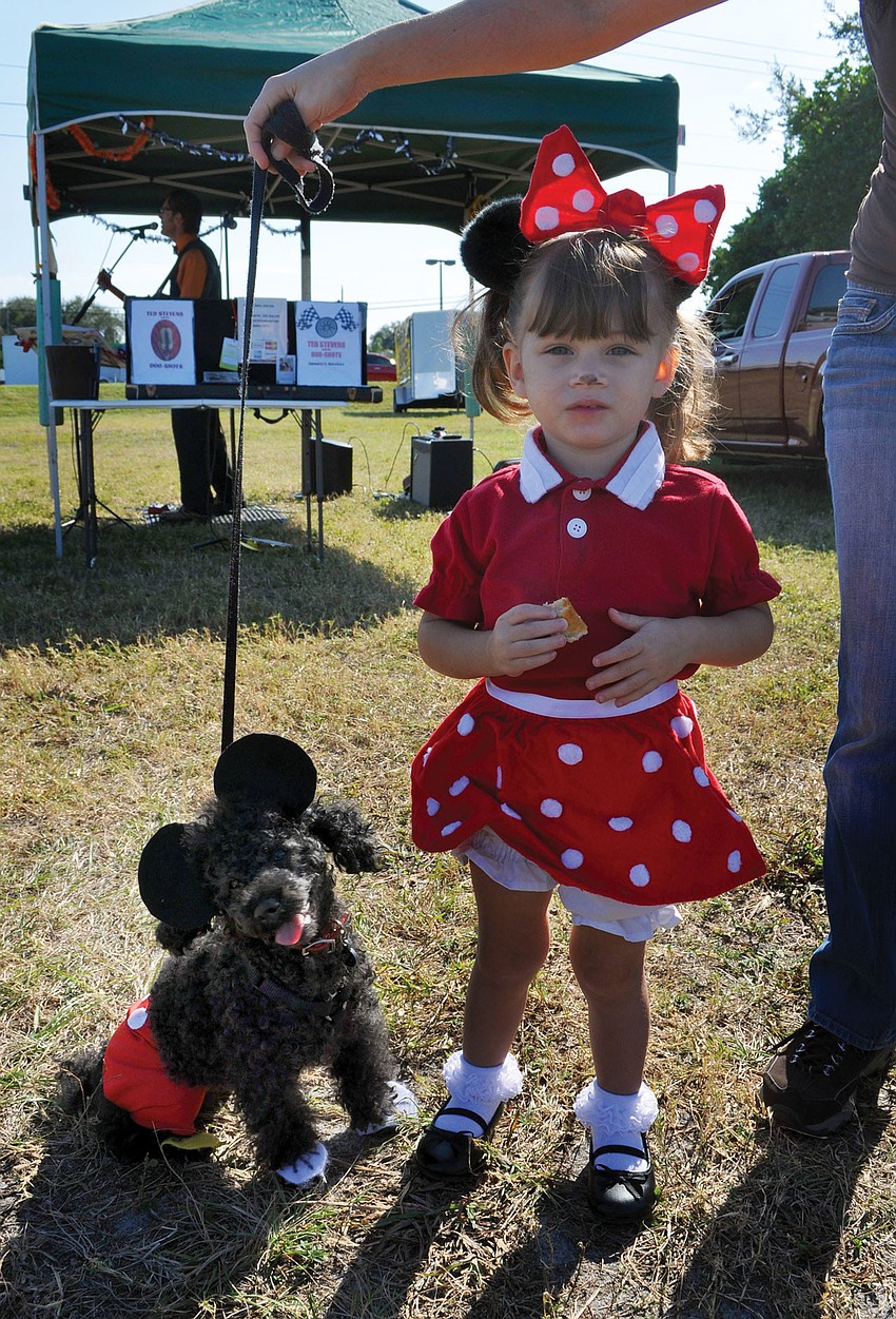 Poe, 9, dressed up at Mickey Mouse to match Charlotte Machado, 2, who dressed up as Minnie Mouse for the Phillippi Farmhouse Market Howl-O-Ween. Poe and Machado won Best Owner/Dog Look Alike.