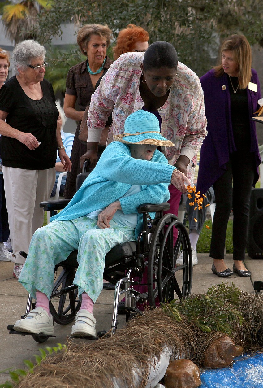 Barbara Slavin dumps her fish crackers into the â€œRiver Jordanâ€ while Betty Jones looks on Tuesday, Sept. 18.