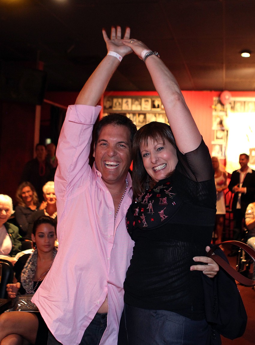 Vicente Medina and Cheryl Geletka celebrate Geletkaâ€™s winning bid on Medina of $2600.