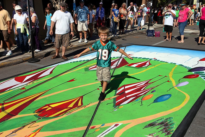 Lincoln Sibley, 6, walks across the tight rope of one of the 3D pieces.
