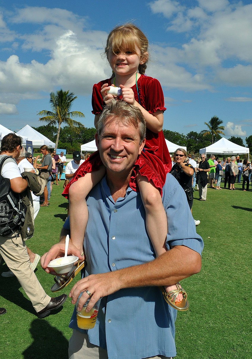 Bryce Hurley gives his daughter Eden, 4, a ride on his shoulders.