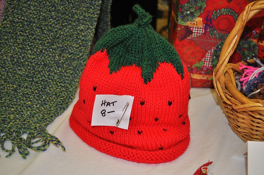 A knitted strawberry hat was one of the many items for sale at the holiday bazaar.