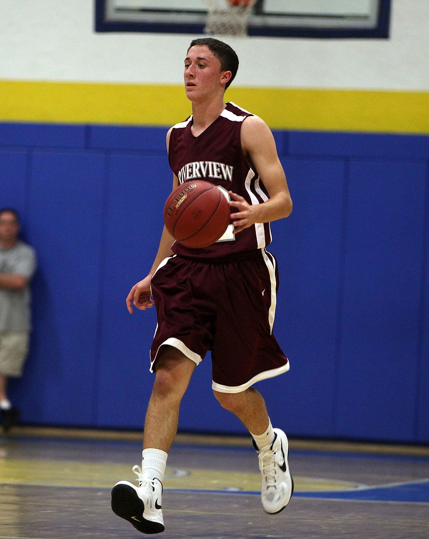 Joshua Yoder, No. 15, dribbles the ball.