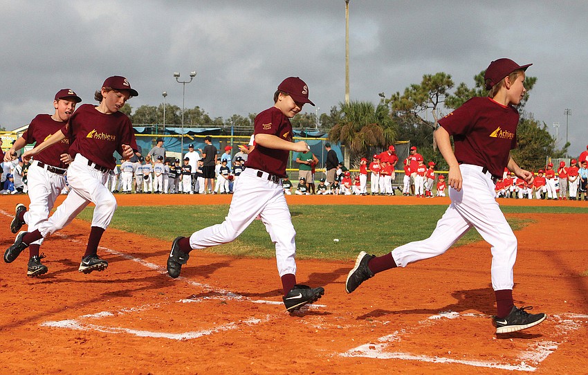 Achieva Maroon trots toward home plate during the Opening Day ceremony at Twin Lakes Park.