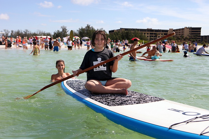 Molly Pyott, 8, tries out paddleboarding.