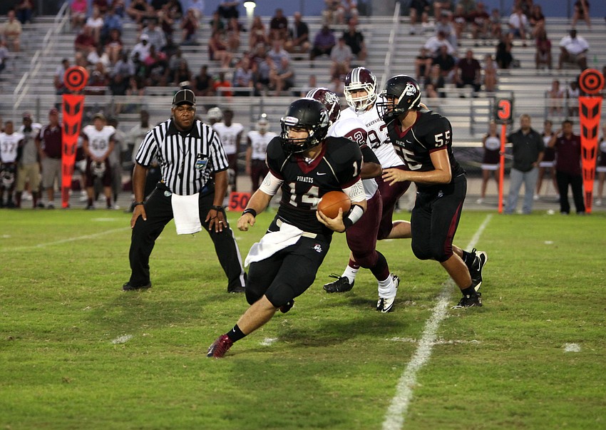 Eric Schappacher, No. 14, handles the ball as he makes his way down the field.