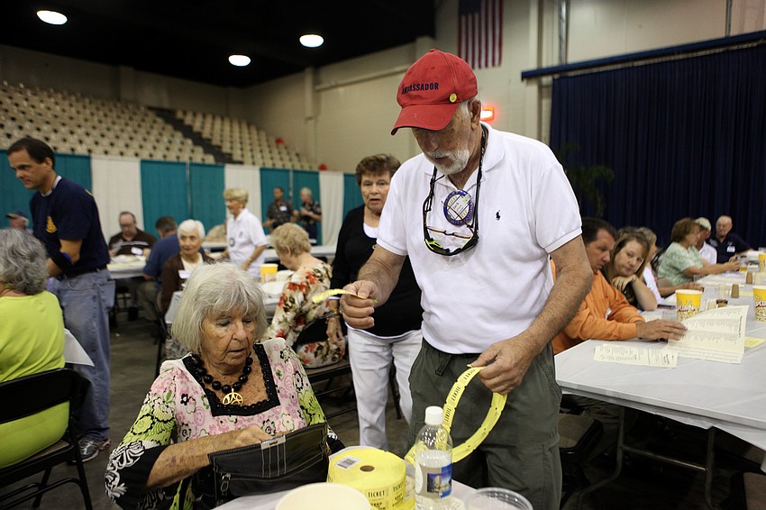 Joyce Ridenour buys raffle tickets from Jack LeFrock Sunday, Oct. 7.