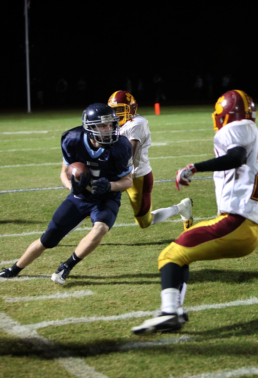 Drew Fineberg, No. 5, tries to get the ball up field while Cardinal Mooneyâ€™s Blair Perry, No. 1, and Alex Sobczak, No. 21, attempt to stop him.