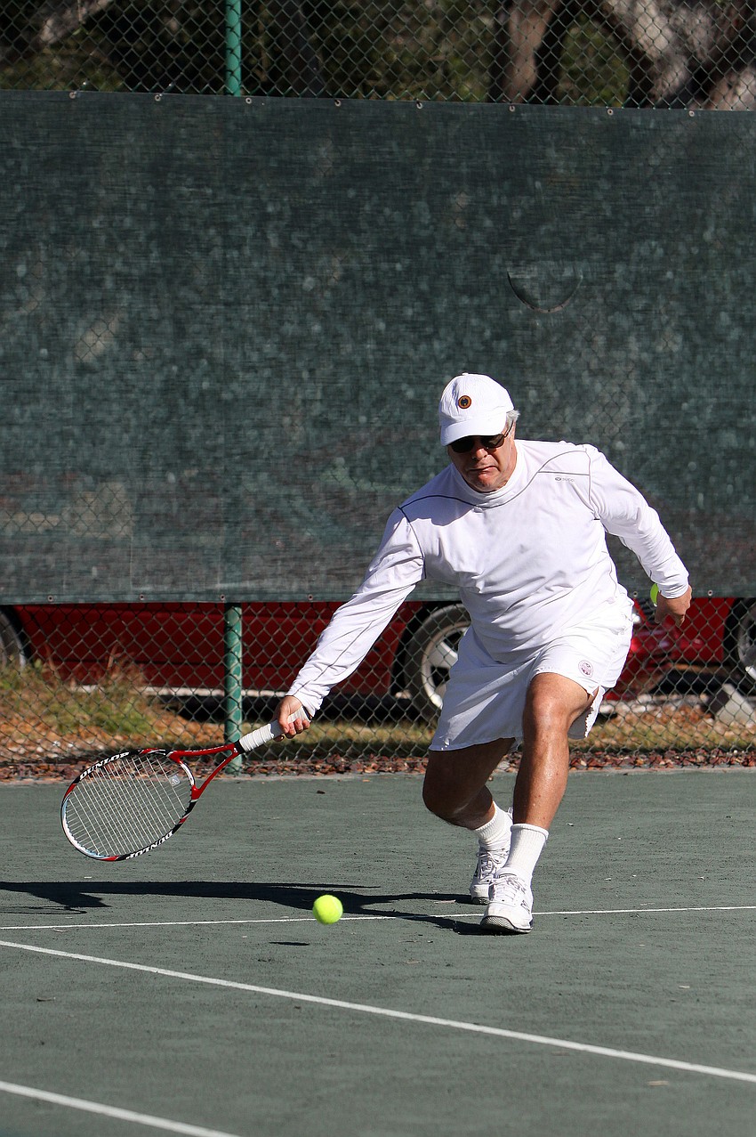 Richard Stoneman bends down to hit a low front hand shot.