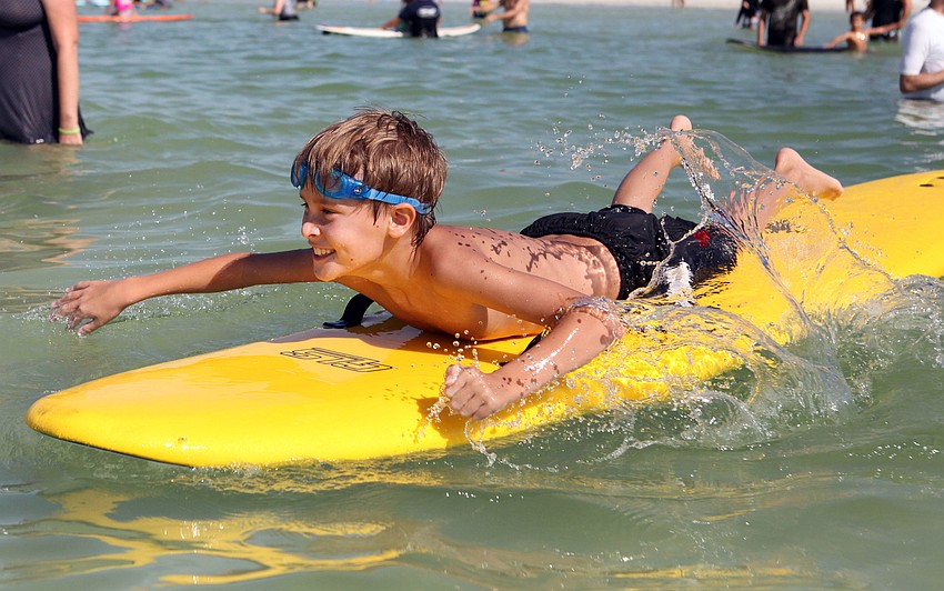 Julian Repetto, 8, paddles back out from shore Saturday, Sept. 15 at Hang 10 for Autism. This was Repettoâ€™s third time participating in Hang 10 for Autism.