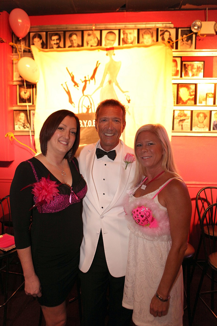 Co-chairs Sarah Wakefield and Amy Tuten pose with emcee and honorary bachelor Walt Willey.