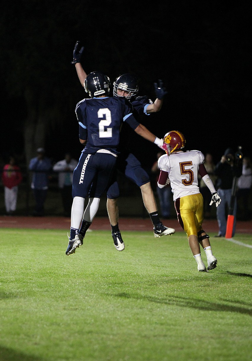 Brandon Place, No. 2, and Drew Fineberg, No. 5, celebrate Finebergâ€™s touchdown.