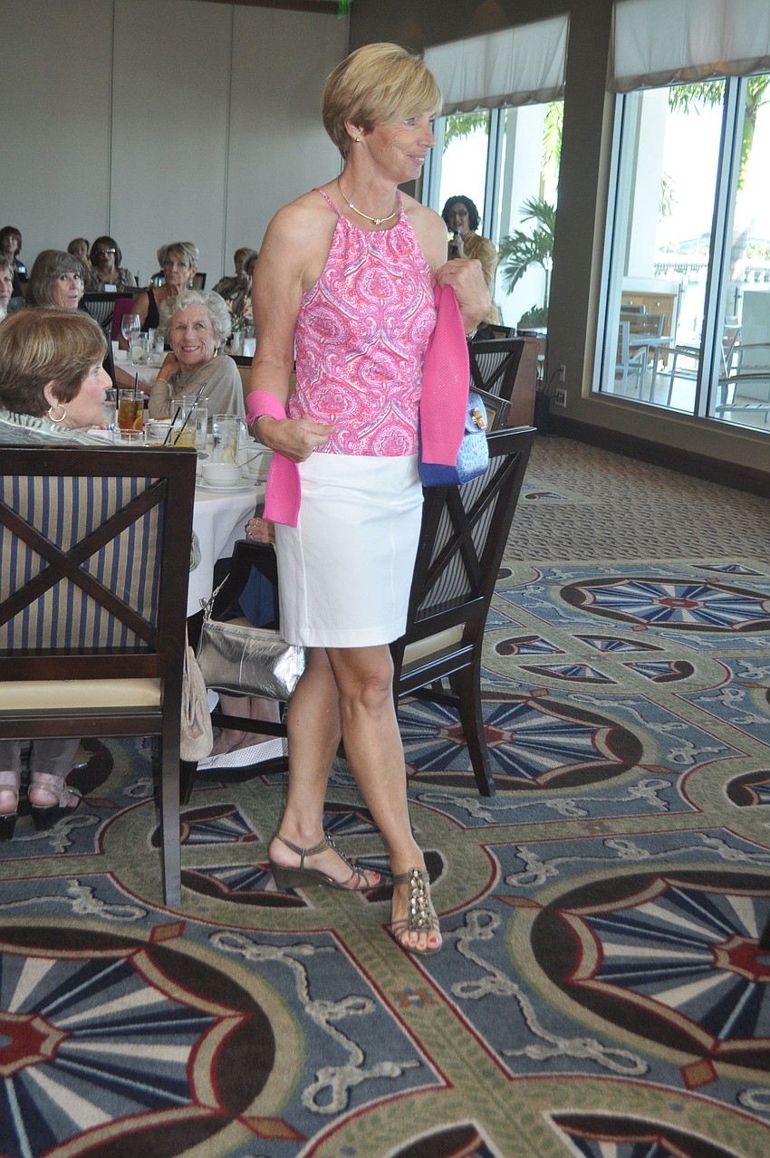 Regina Repenning struts through the Sarasota Yacht Club dining room