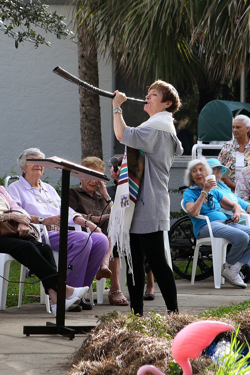 Rabbi Barbara Aiello blows the shofar horn as part of the Tashlich ceremony Tuesday, Sept. 18 by the Anchin Pavilion.