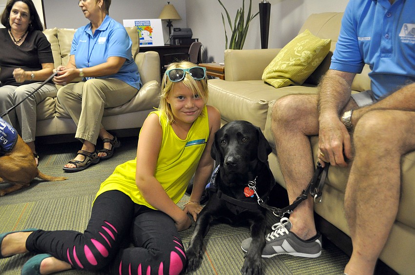 Isabelle Duke relaxes with certified therapy dog and ambassador, Lindy.