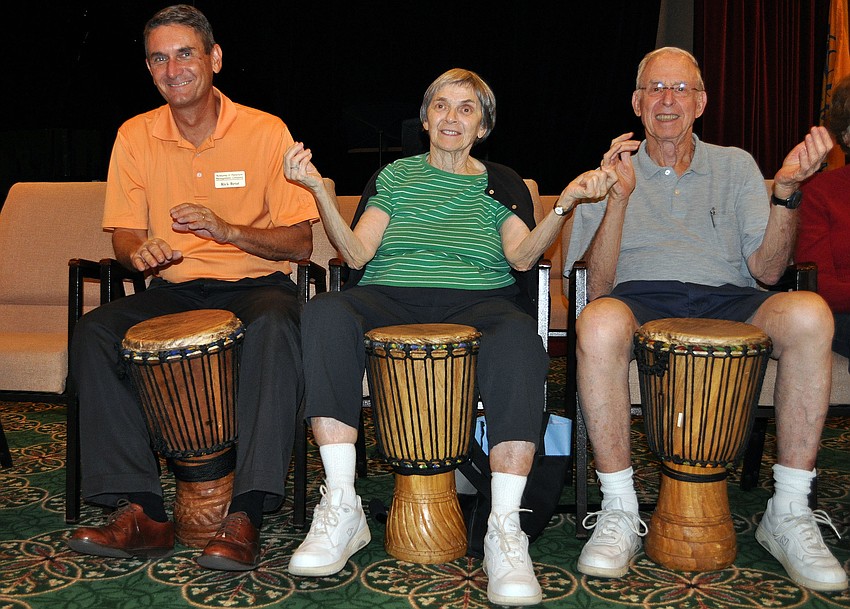 Rick Betat and Judy and Donald Markstein attempt to drum, snap and clap to the beat Monday, Sept. 24 during the drum circle at Sarasota Bay Club.