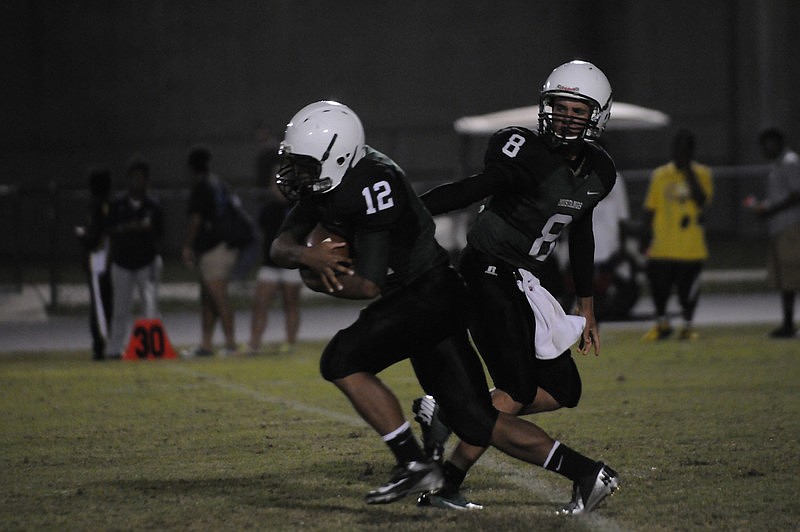 Running back Chris Pearcey receives the handoff from quarterback Chad Rex.