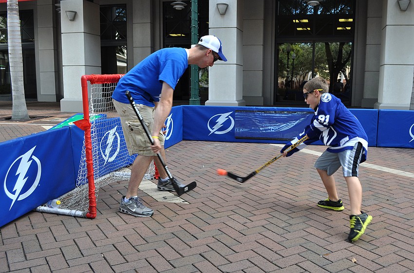 Ryan Cronin, community hockey intern, plays goalie against Jacob Dreels, 8.