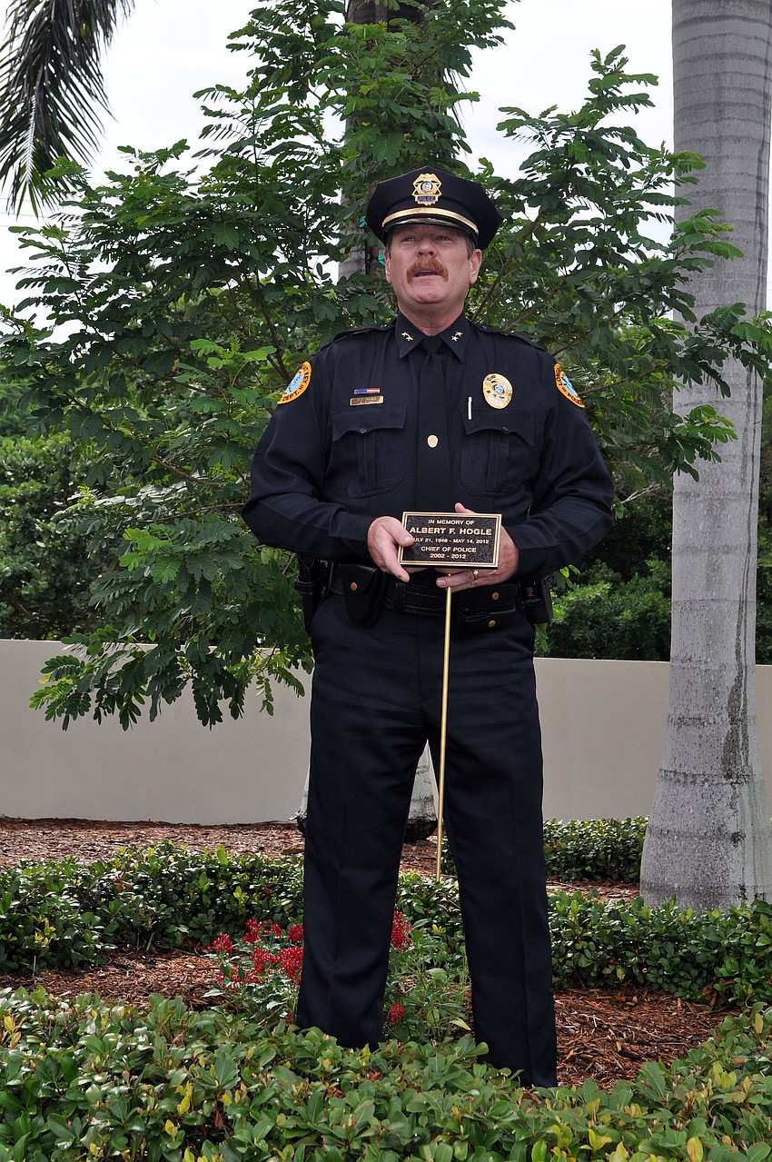 Longboat Key Police Chief Peter Cumming holding the plaque that will place in front of the tree that was planted in honor of Al Hogle Wednesday, Oct. 3 at the Longboat Key Police Station.