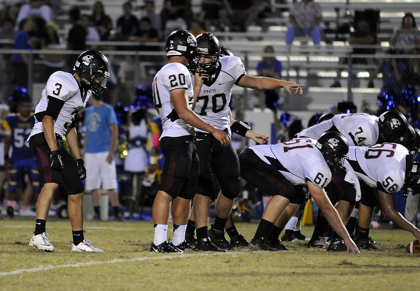 Junior linebacker Marcus Balliette goes over the play call with senior offensive lineman Matt McKoan.